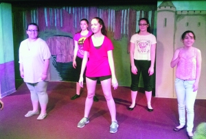 Getting their act together...Showing their passion for community theater, (from left) Shrek Jr. cast members Kiara Jacoby, Chelsea Sharp, Emma Ford, and Nicole Nadwodny prepare to run through the song “Make A Move“ at the Montgomery Theater.  